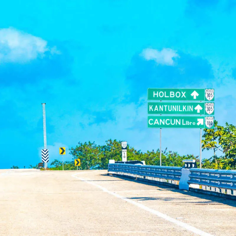 a highway in cancun with road sign 