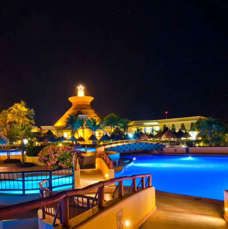 Resort pool are at night lit-up 