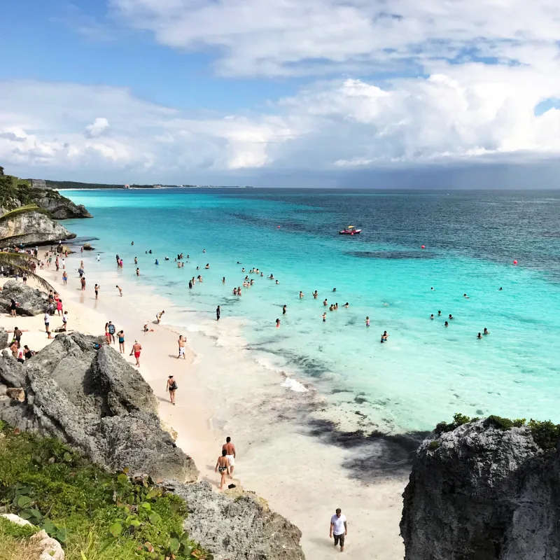 Tulum beach with swimmers enjoying the sea