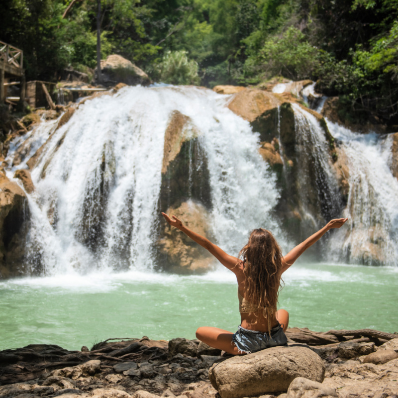 Woman looking at waterfall in Chiapas, Mexico