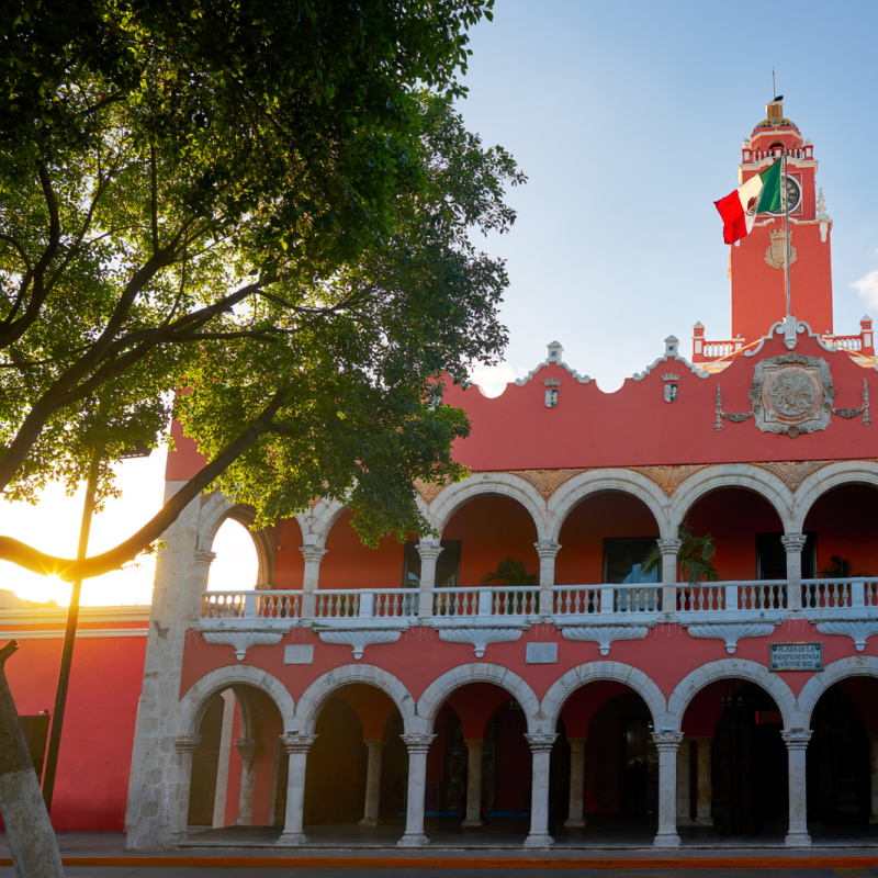 colorful colonial building in merida with sunrise