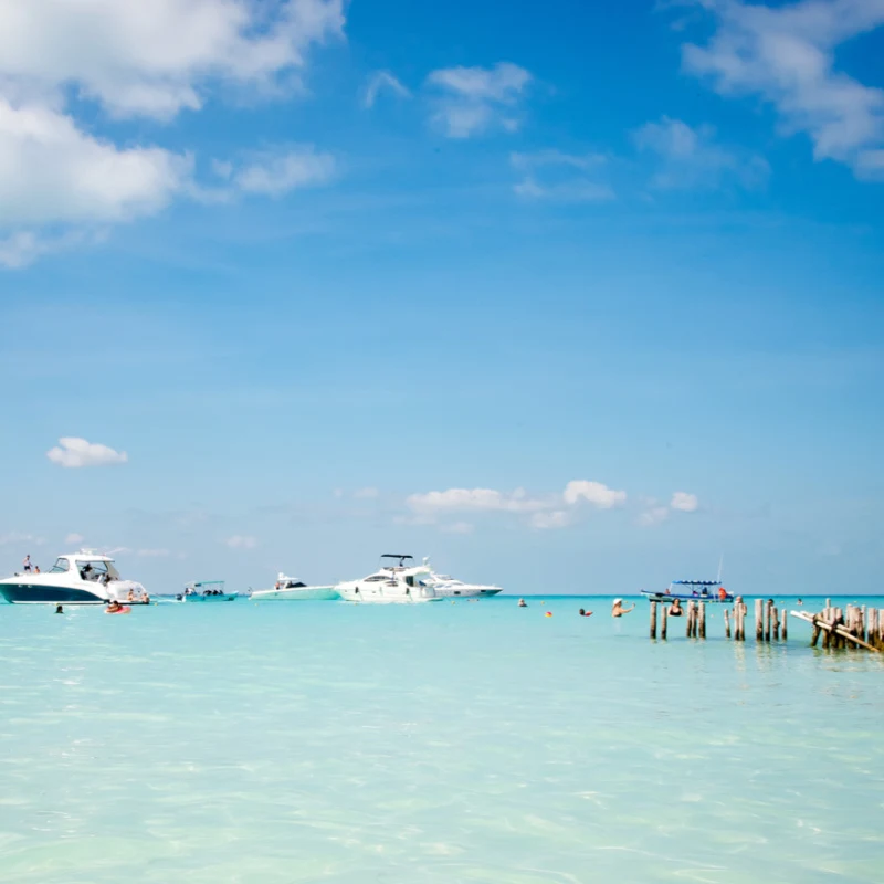 turqouise water sea with boats and tourists in the mexican caribbean