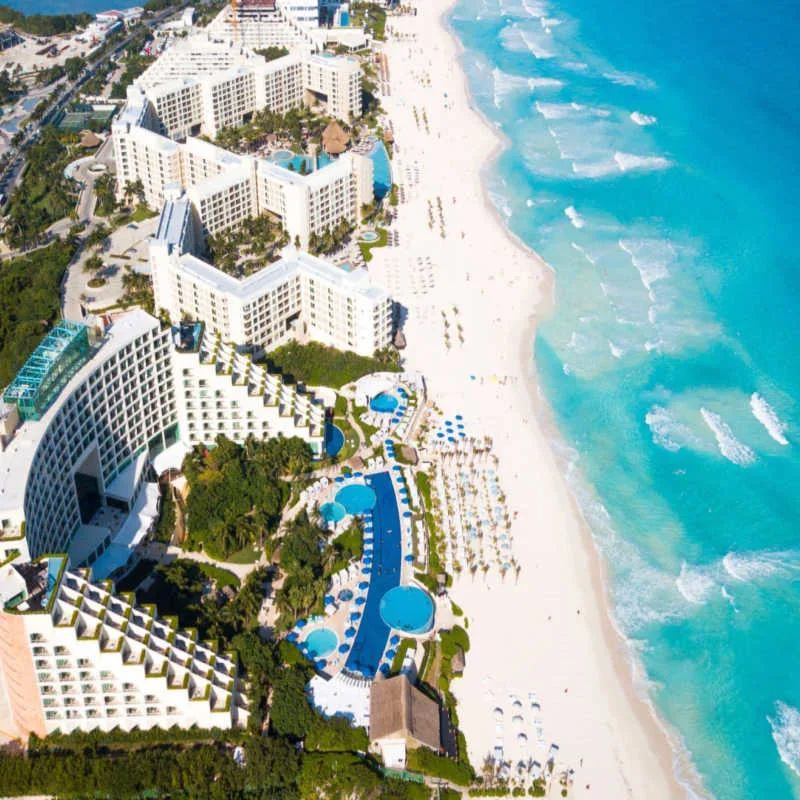 a white sand beach in cancun with resorts