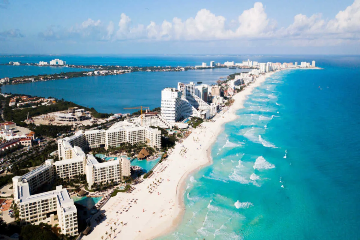 Aerial view of a long white sand beach in cancun