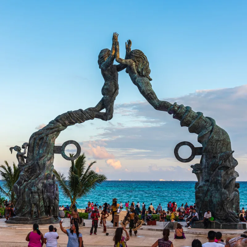 famous playa del carmen statue on beach with busy tourists
