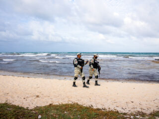 Military Guards Walking on a Beach in Tulum, Mexico