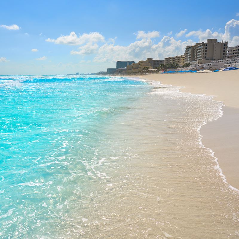 Playa Marlin in Cancun Hotel Zone, with crystal clear waters and resorts in the background