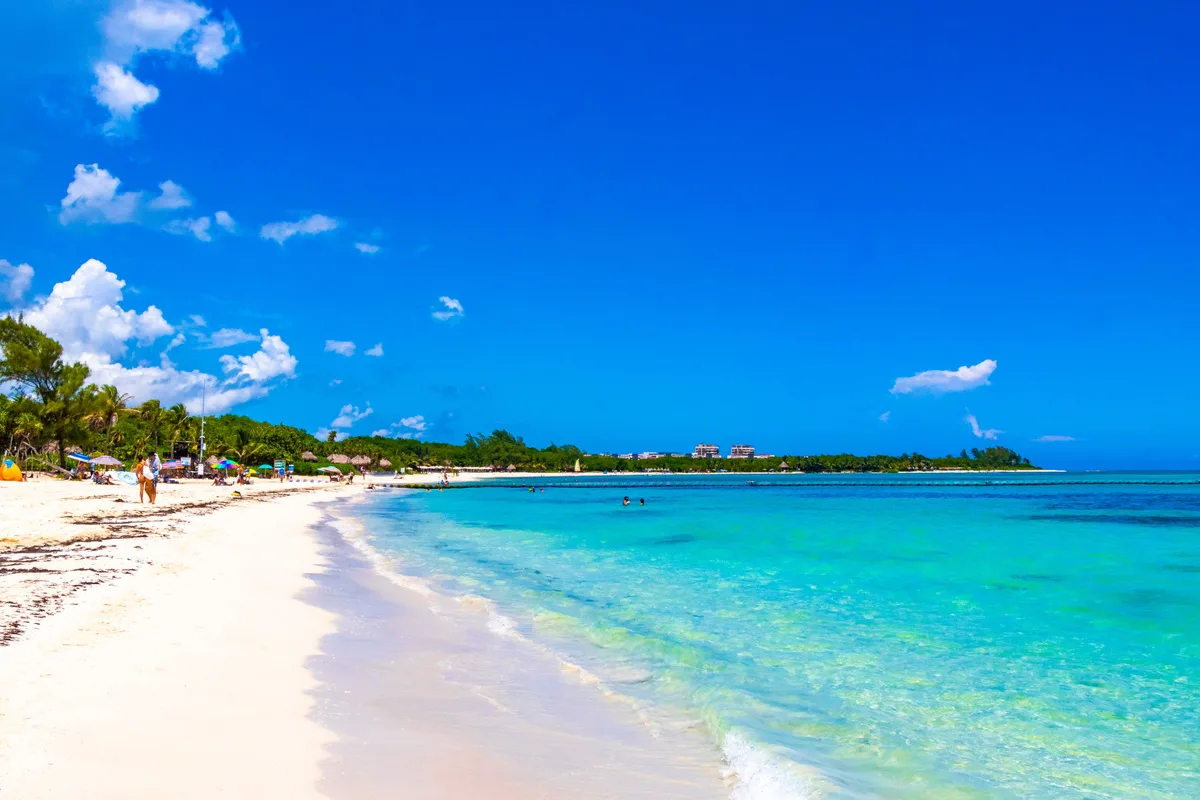 crystal clear blue water and sugary white sandy beach in playa del carmen