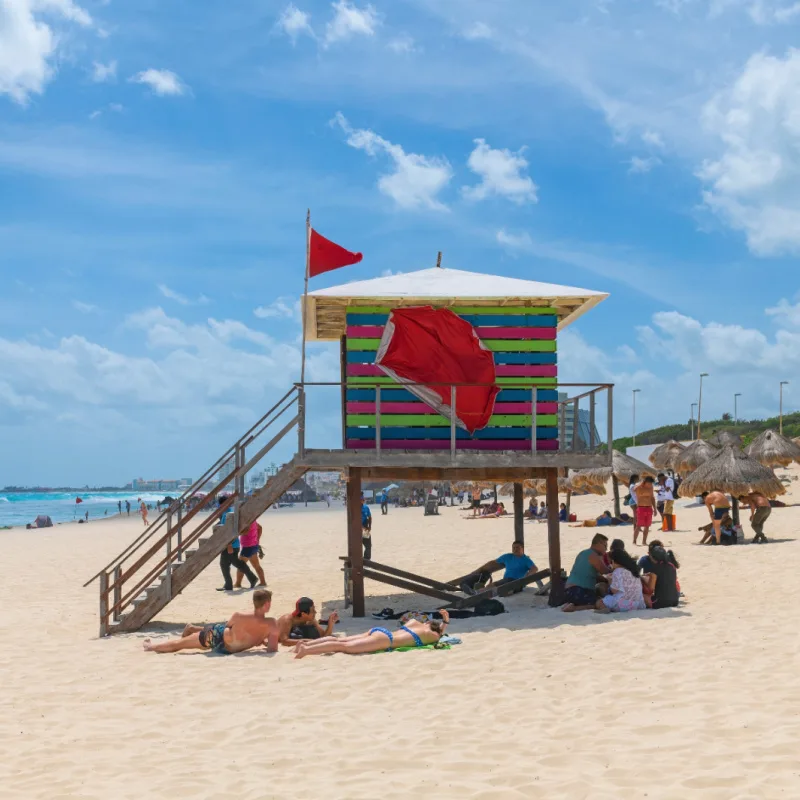 Tourists Sitting Around a Lifeguard Station in Cancun, Mexico