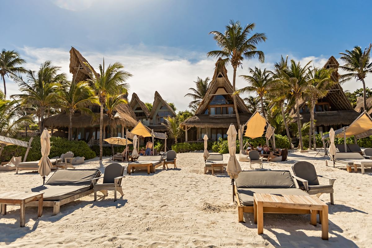 Tulum eco resort with sun loungers and palm trees