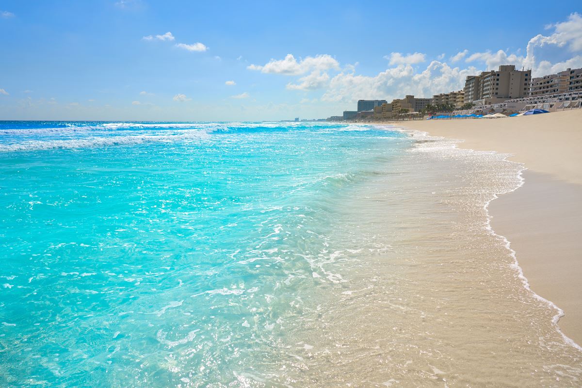 Playa Marlin in Cancun Hotel Zone, with crystal clear waters and resorts in the background
