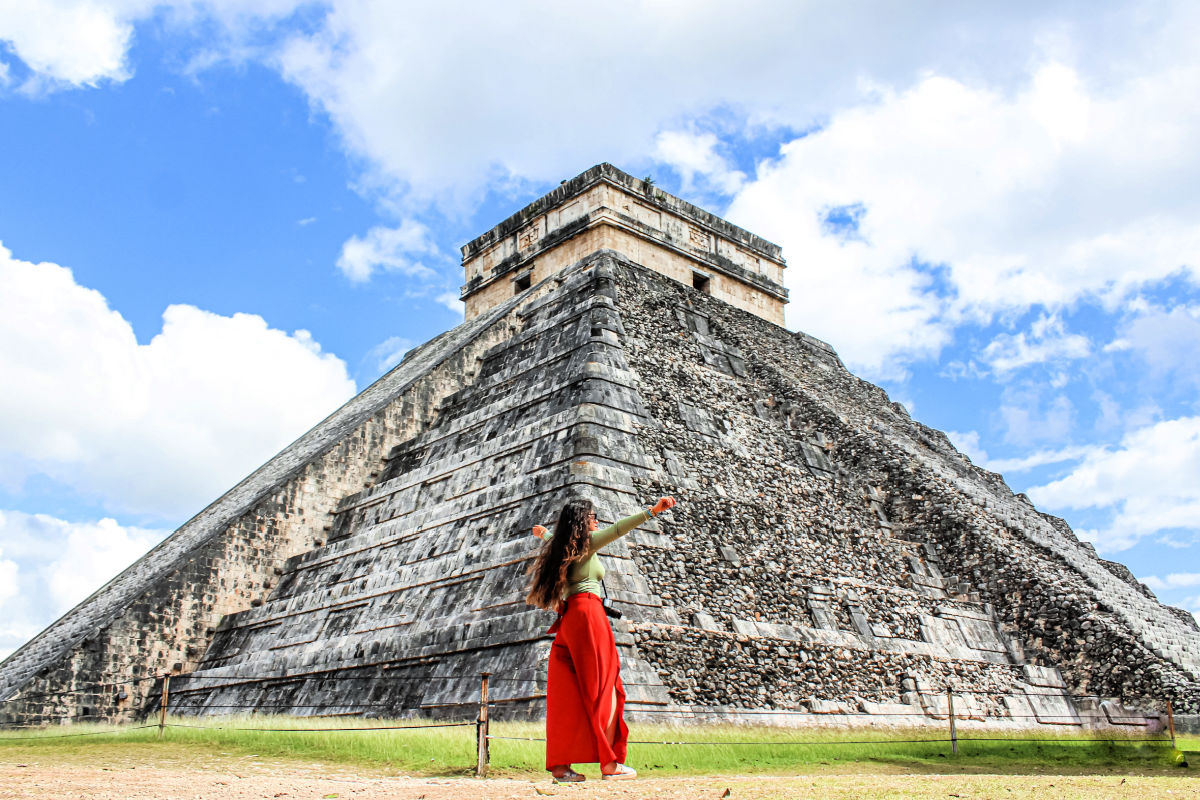 Woman standing at Chichen Itza site in Mexico