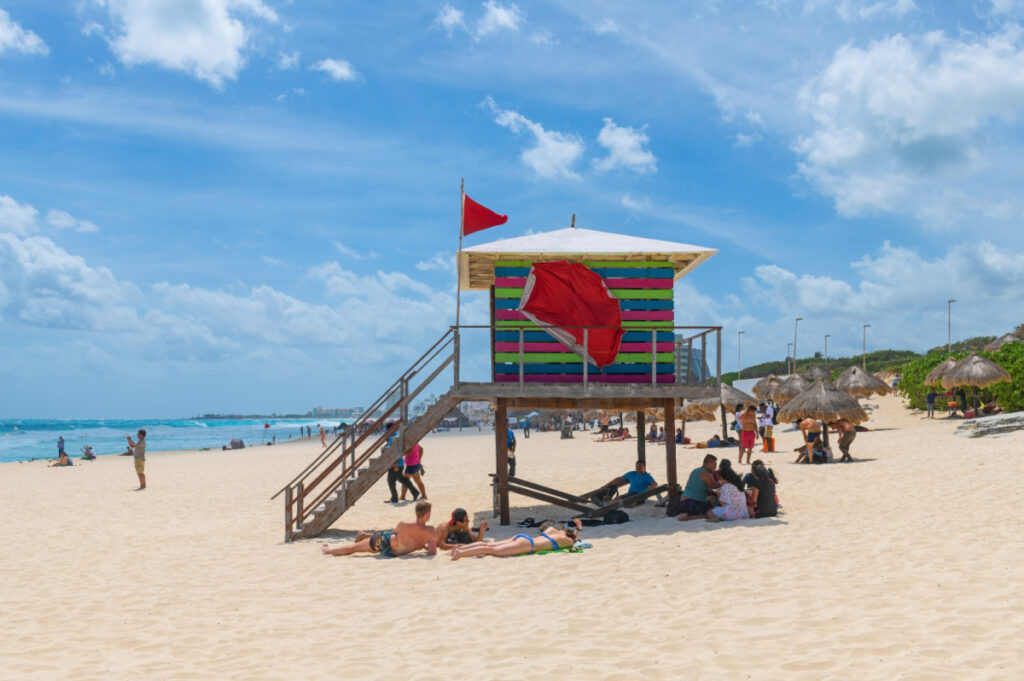 Tourists Sitting Around a Lifeguard Post in Cancun, Mexico