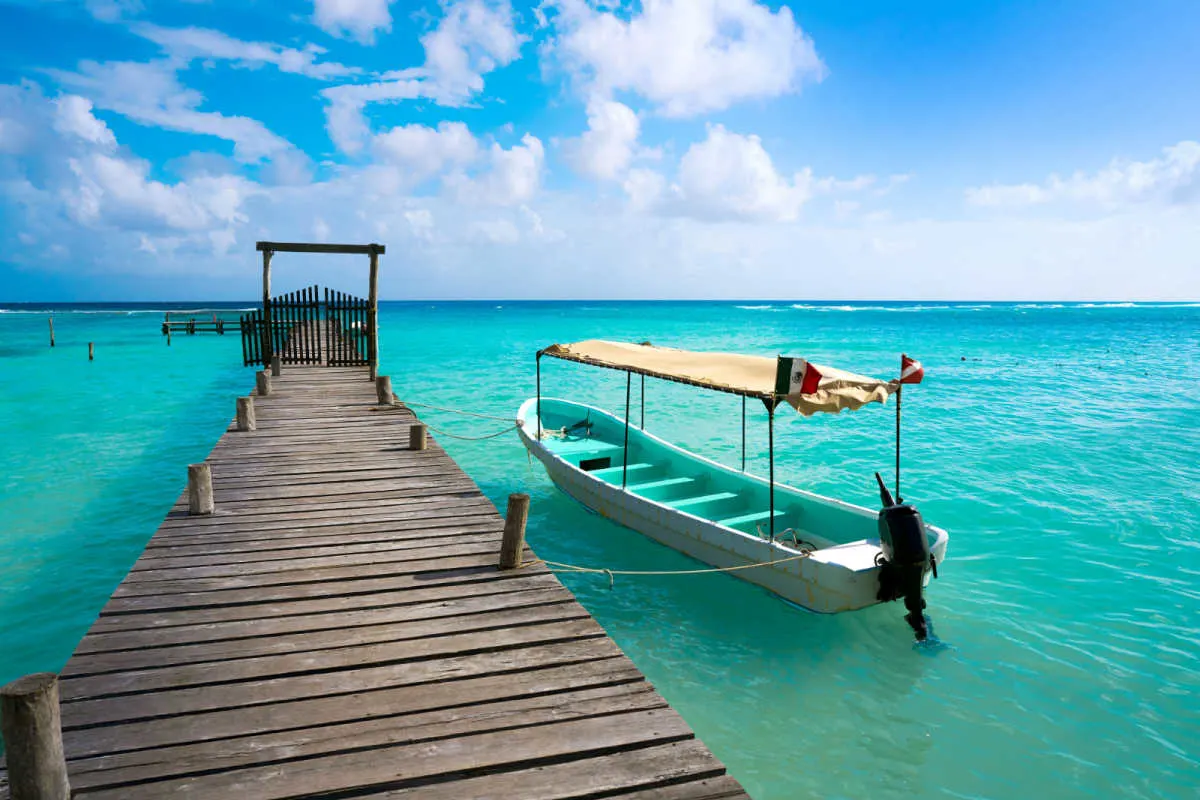 A blue ocean and a boat in the costa maya