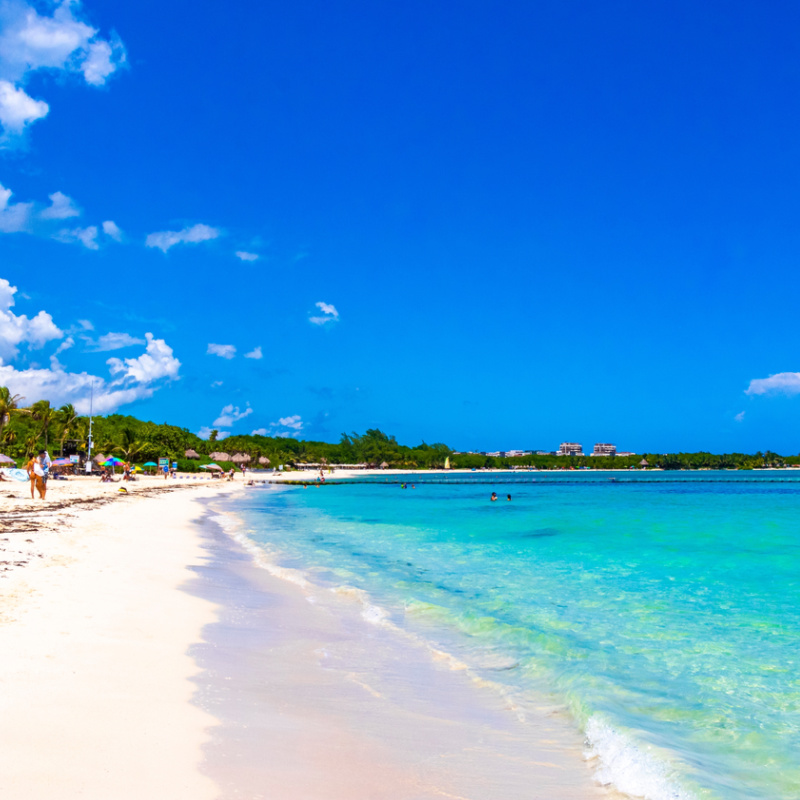 crystal clear blue water and sugary white sandy beach in playa del carmen