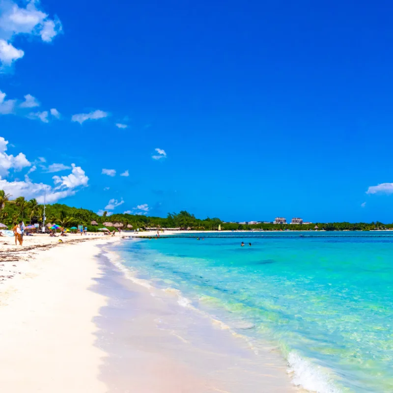crystal clear blue water and sugary white sandy beach in playa del carmen