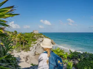 Tulum Ruins with tourist looking in the distance