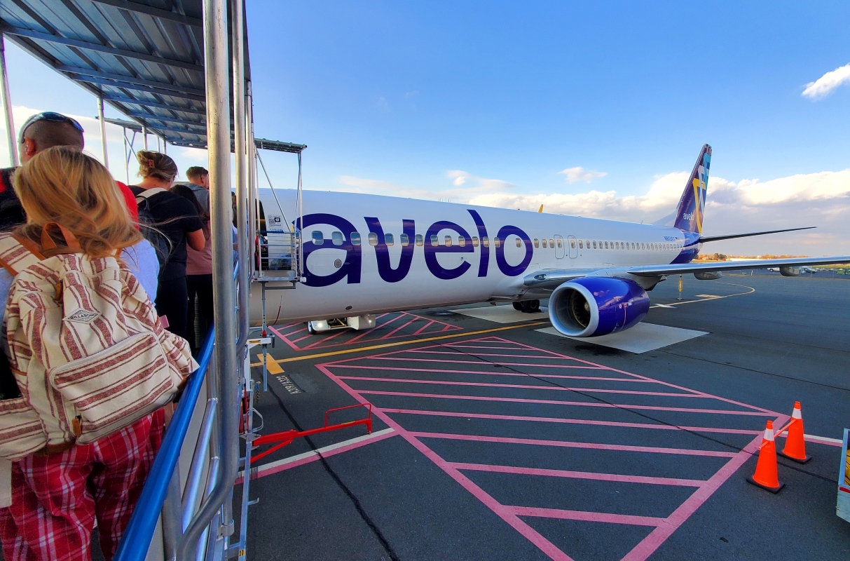 Passengers waiting in line to board Avelo Airlines flight