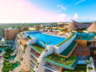 Aerial tour over a luxurious 5-star hotel resort next to the beautiful beaches of Cancun with sunny weather