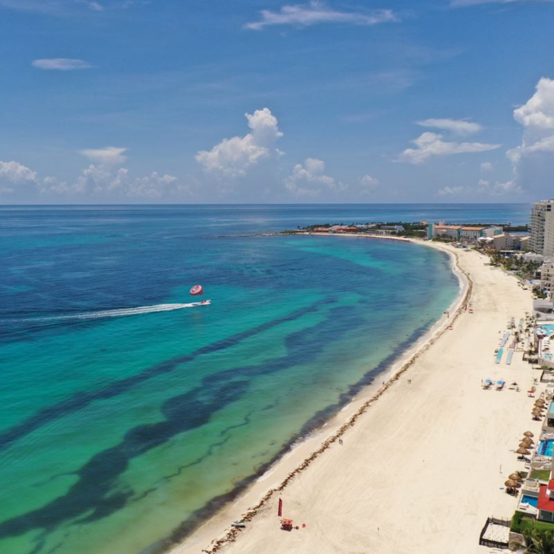 Cancun Hotel Zone with sargassum on the sea and the beach