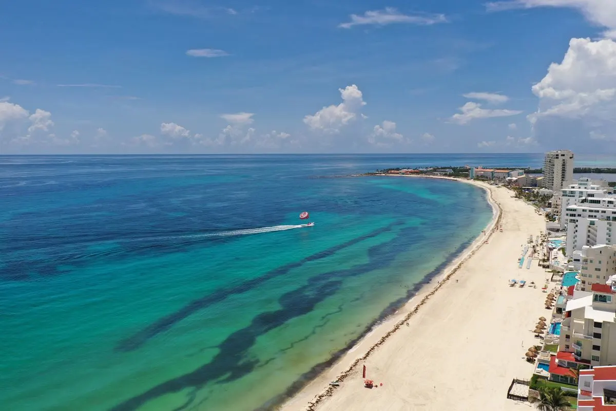 Cancun Hotel Zone with sargassum on the sea and the beach