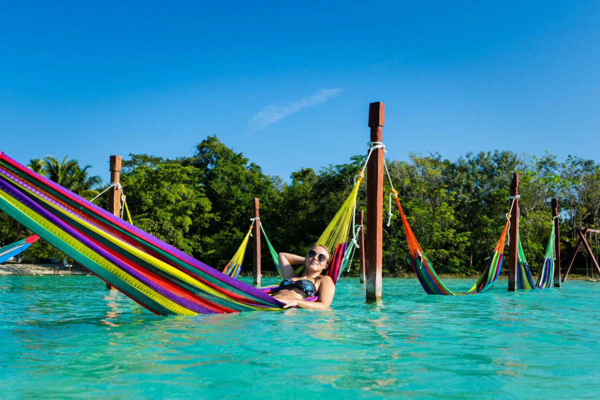 Female Tourist Lounging in a Hammock in the Bacalar Lagoon in Bacalar, Mexico