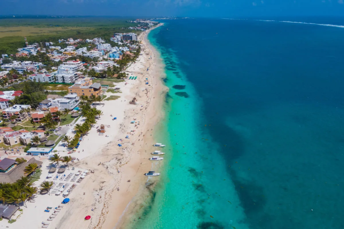 aerial view of a long white sand beach in puerto morelos