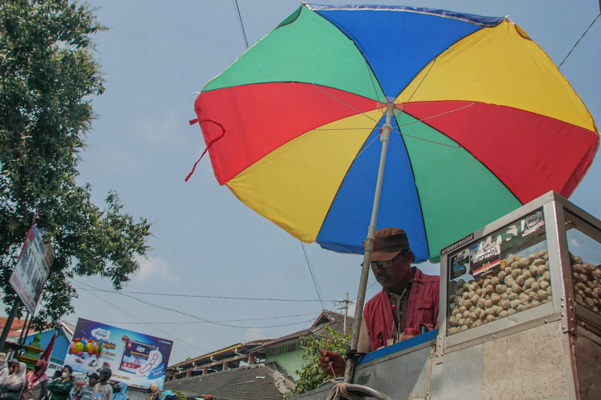 street vendor in Mexico with colorful umbrella