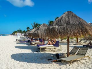 Tourists relax at the beach at Finest Playa Mujeres Resort in Cancun, Mexico
