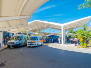 Shuttles, Tourists, and Drivers Outside of Cancun Airport