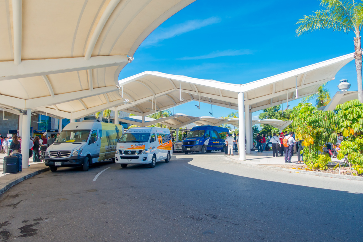 Shuttles, Tourists, and Drivers Outside of Cancun Airport