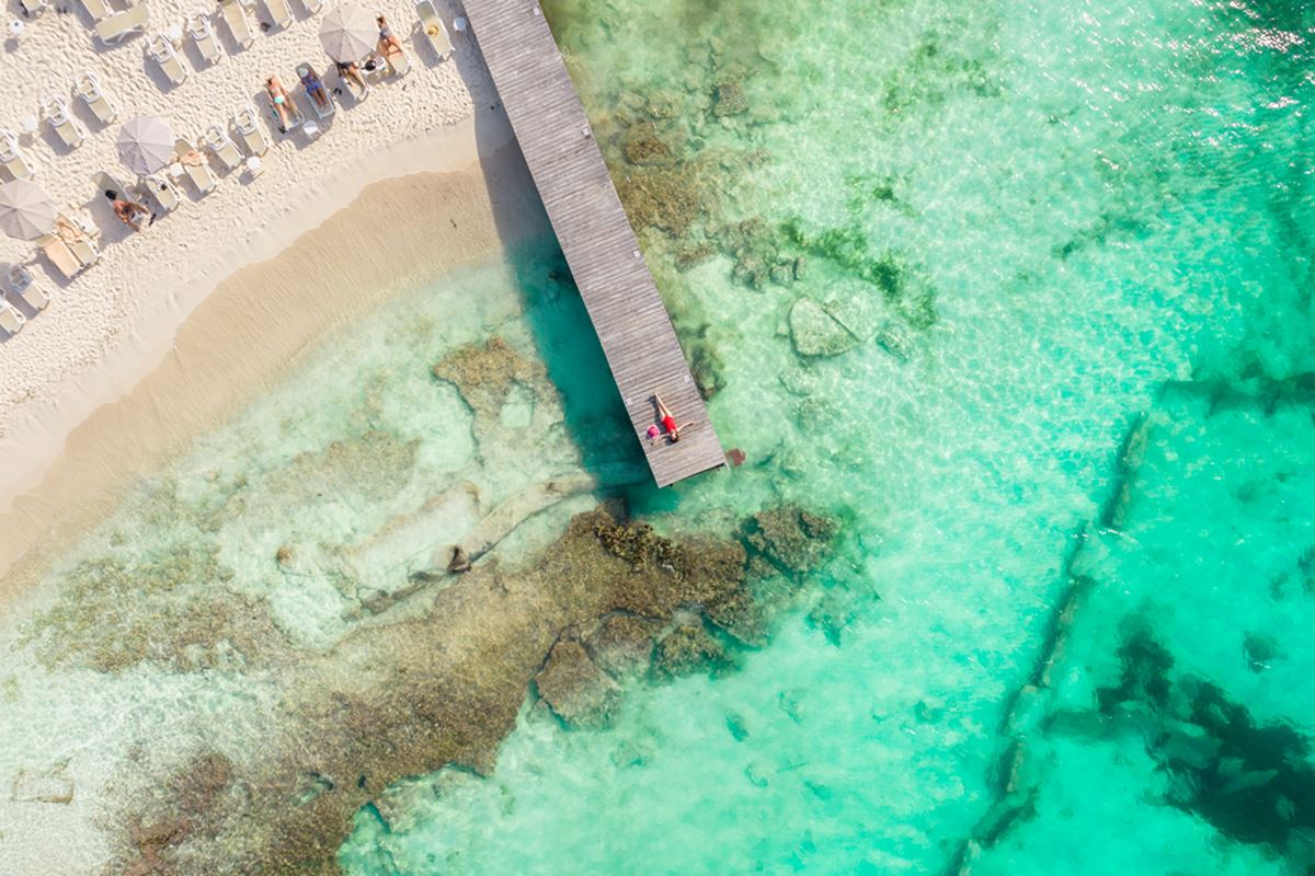 Aerial view of Cancun tourists lounging on the beach and dock