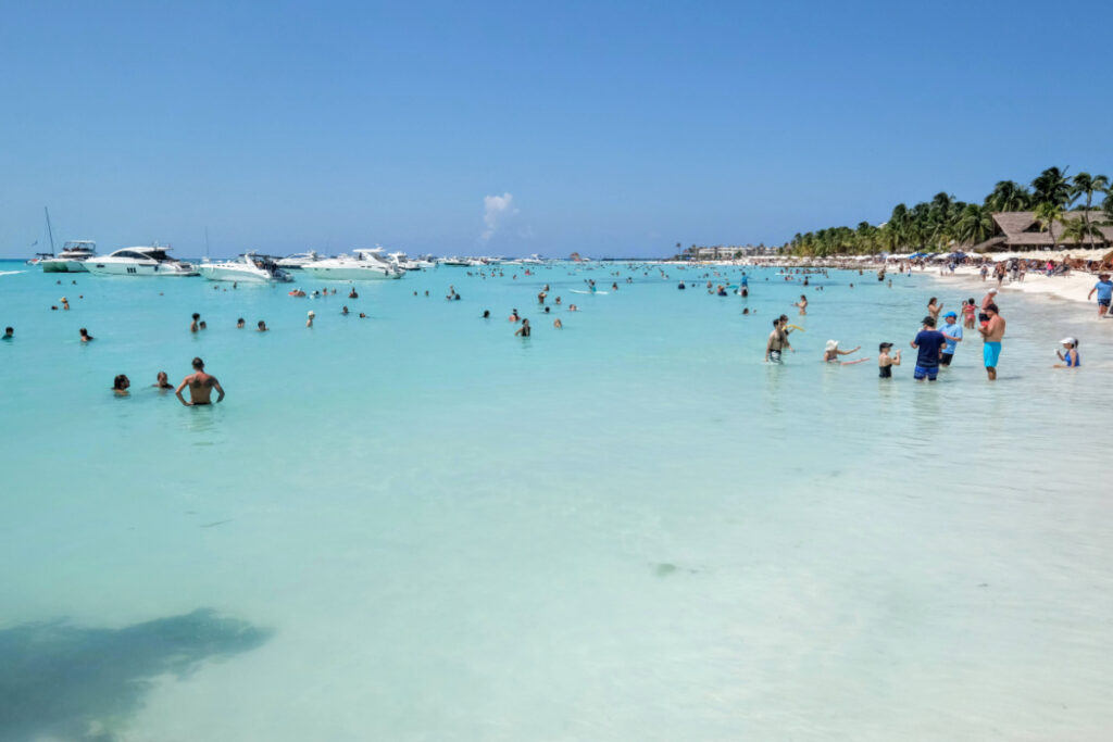 Tourists and Boats in the Water at a Beach in Isla Mujeres, Mexico