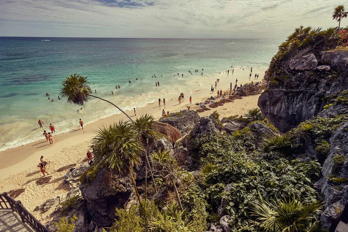 Tulum beach with tourists on a sunny day