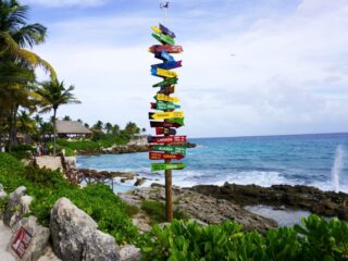 Multi-directional sign with wooden arrows at Xcaret Park