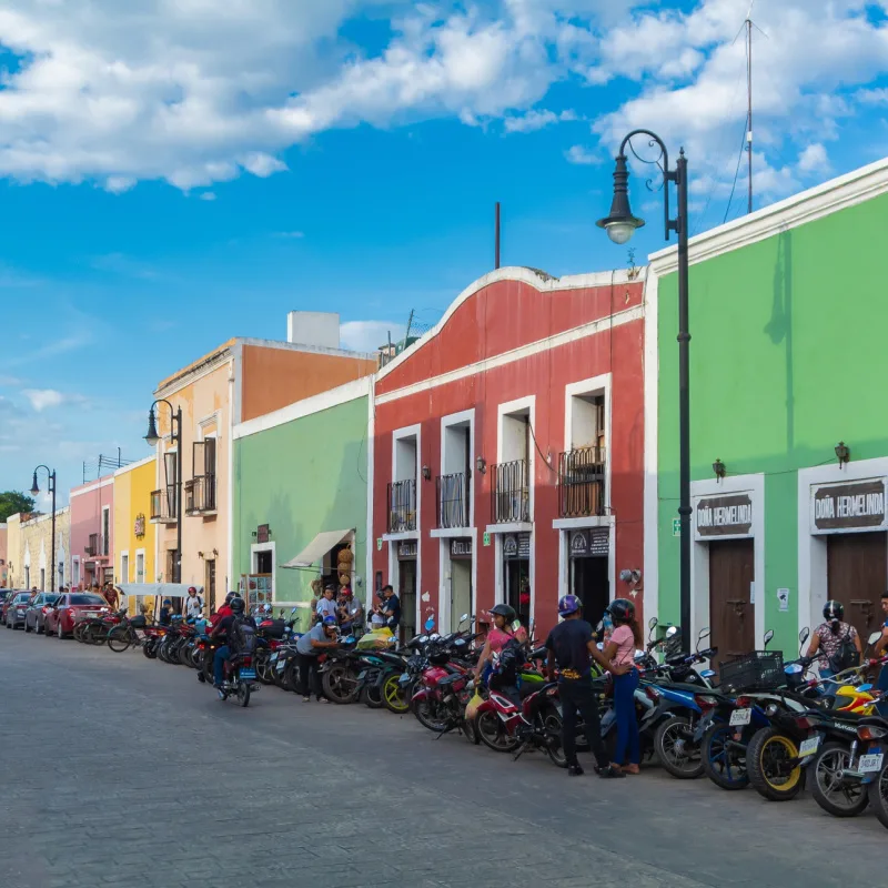 pastel painted streets of Valladolid with motorbikes
