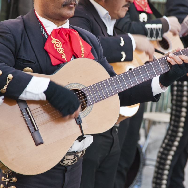 A mariachi playing the guitar
