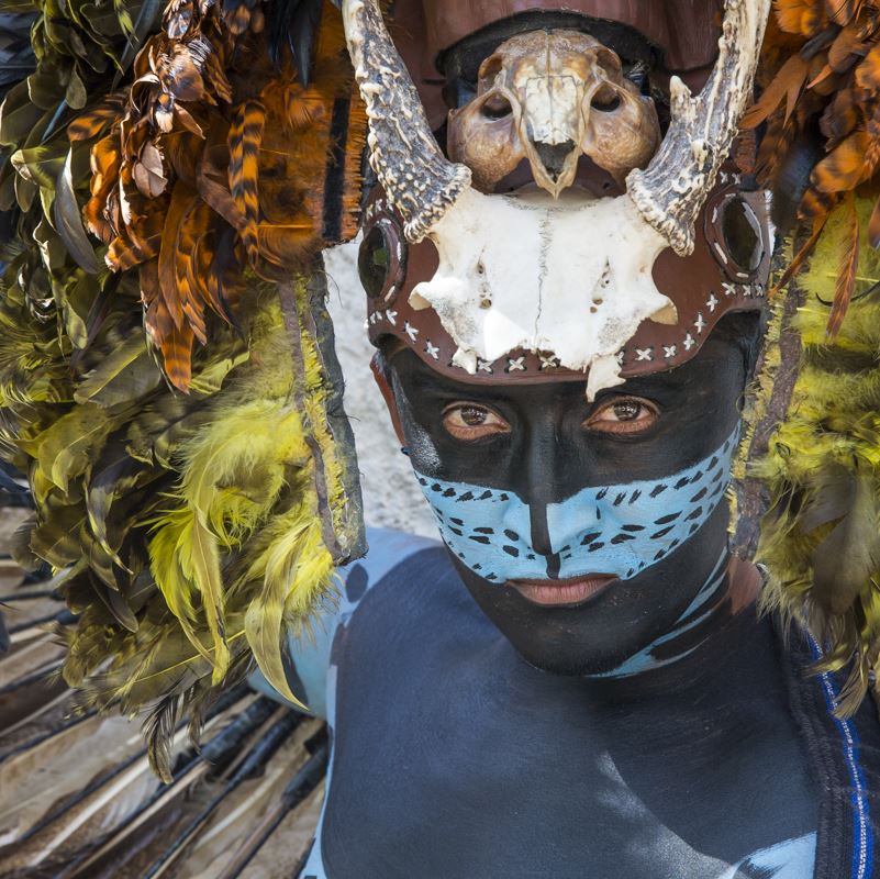A Mayan man dressed in traditional dress and body paint