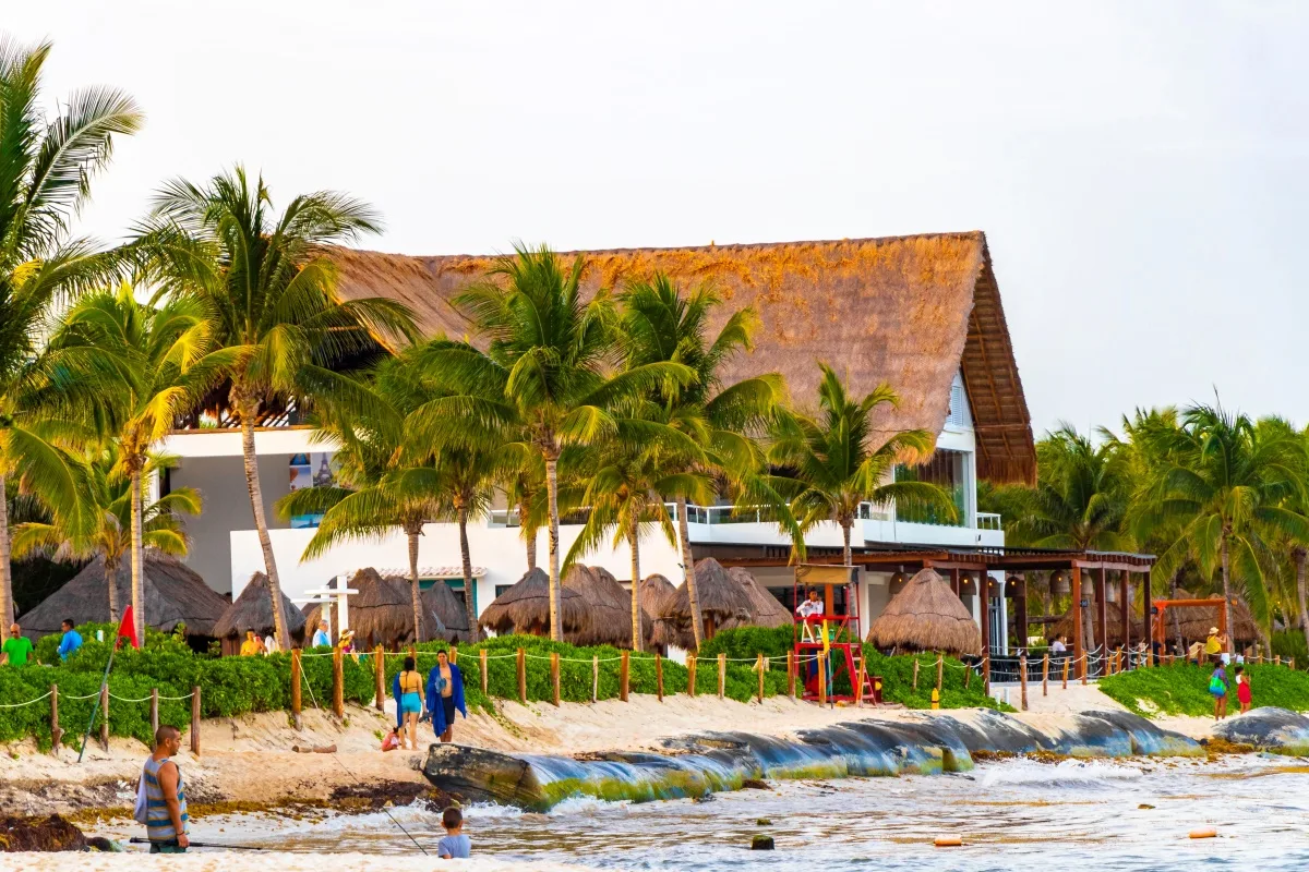 Huge resort and hotel complex on Caribbean beach sea and palm trees in Playa del Carmen Quintana Roo Mexico.
