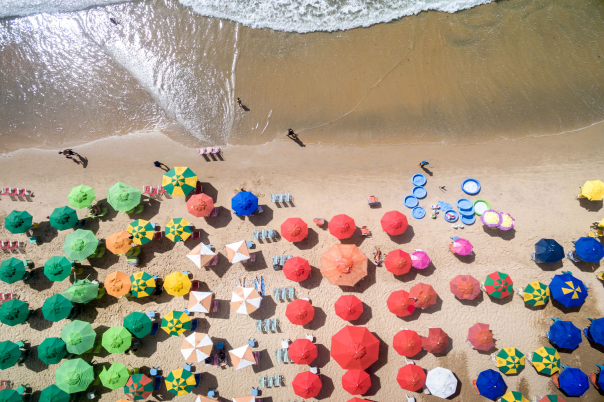 aerial image of a beach in cancun with colorful umbrellas