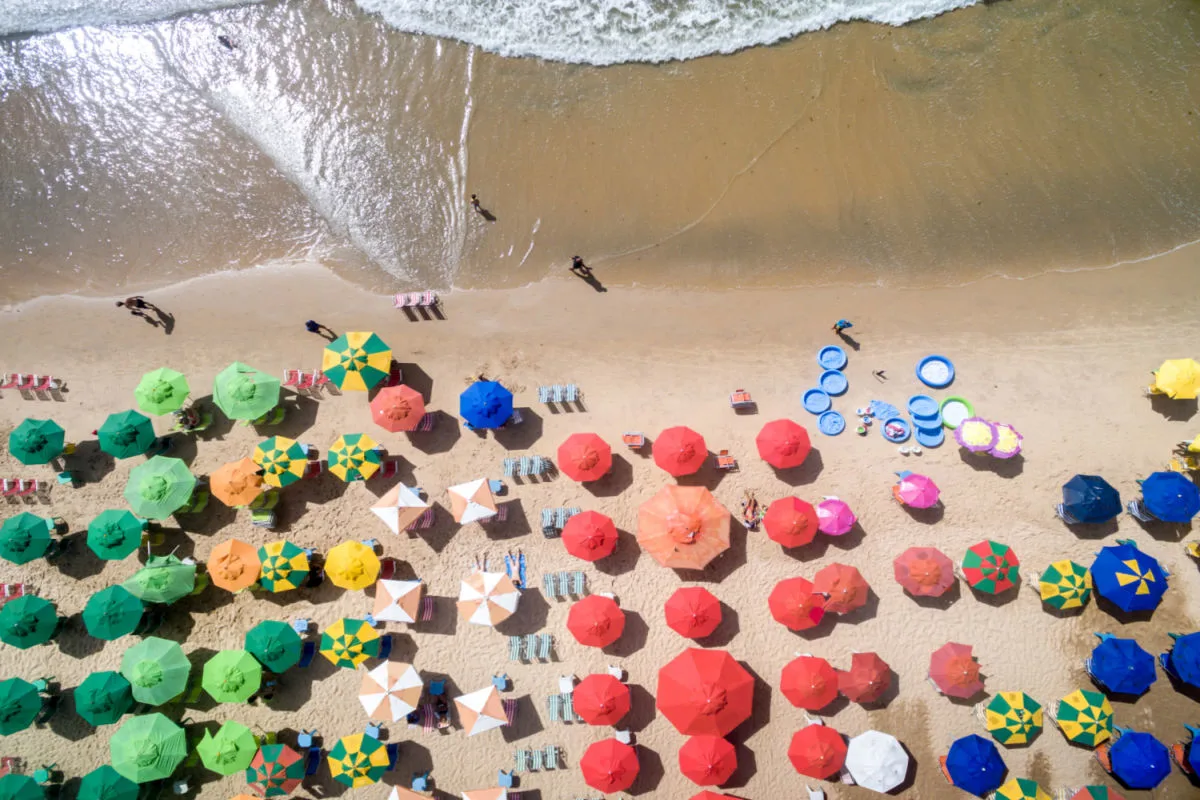 aerial image of a beach in cancun with colorful umbrellas