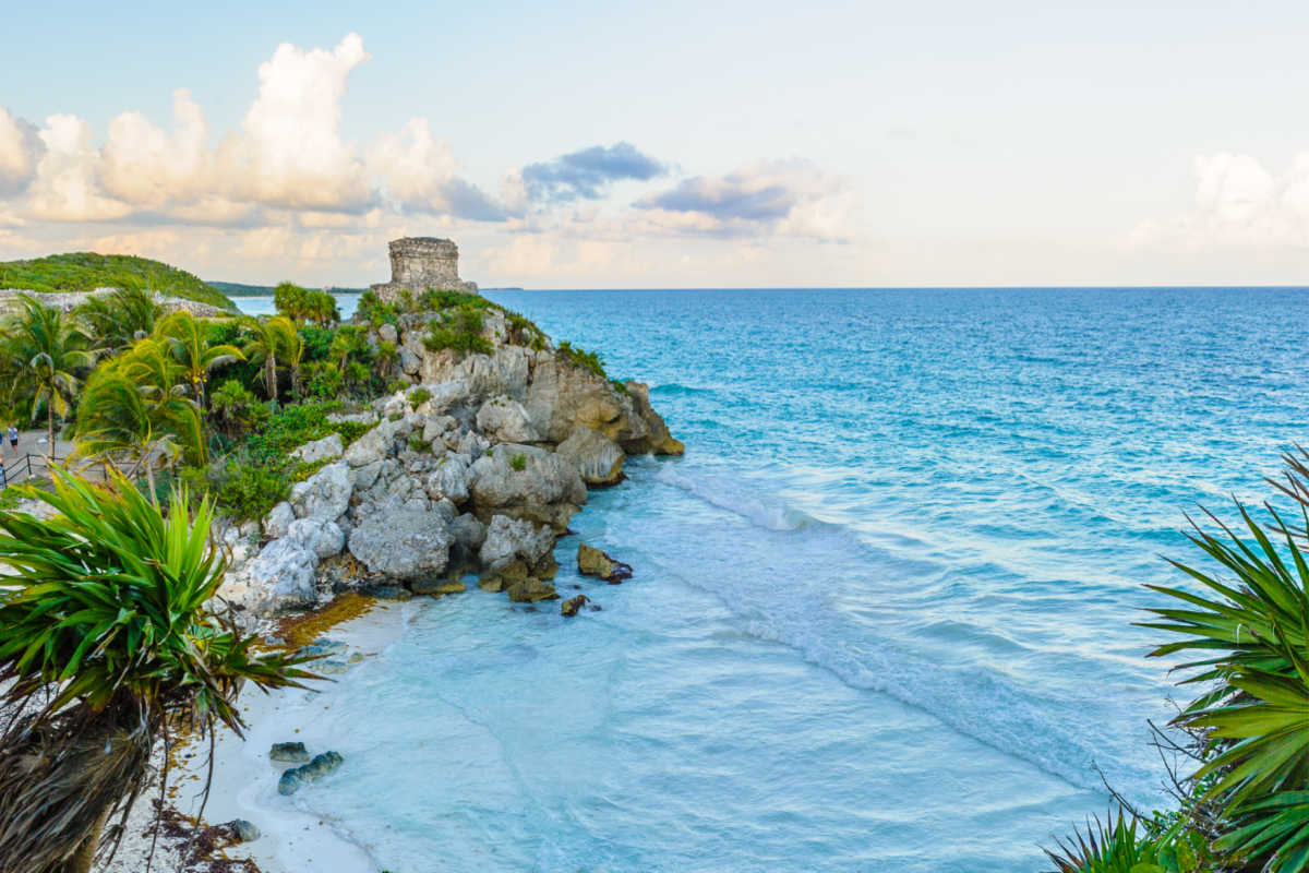 a white sand beach in tulum with nature
