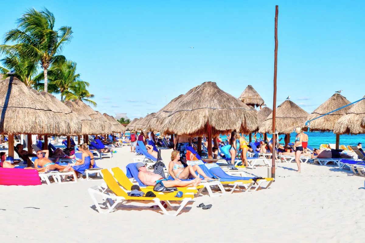 Tourists on a busy beach in Cancun