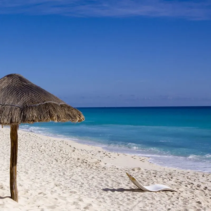 Beach palapas and sun lounger in Cancun public beach
