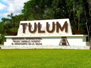 Beautiful Green Grass In Front of the Tulum Airport Sign