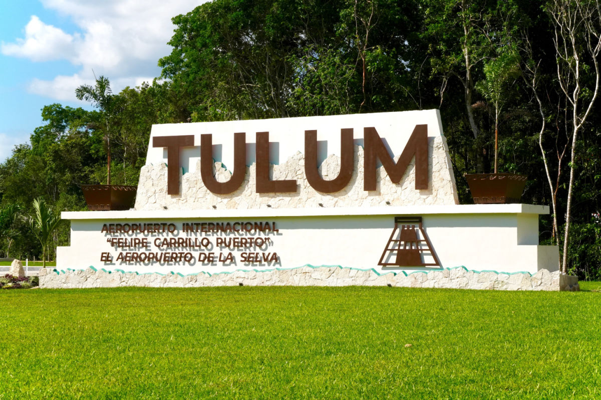 Green Lawn and Sign In Front of Tulum Internatinal Airport
