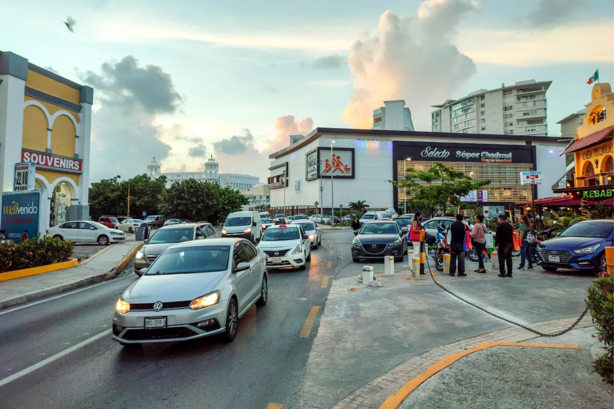 Small Cars and People on a Street in Cancun, Mexico