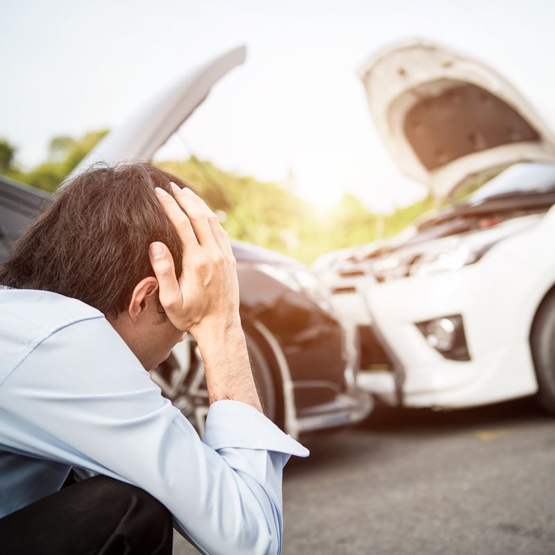 Frustrated man at car accident scene