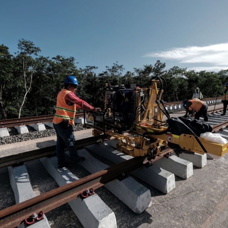 workers fixing the maya train tracks