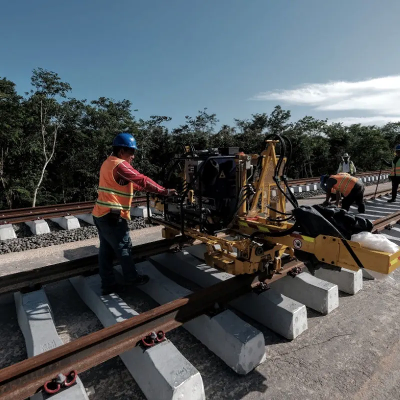 workers fixing the maya train tracks 